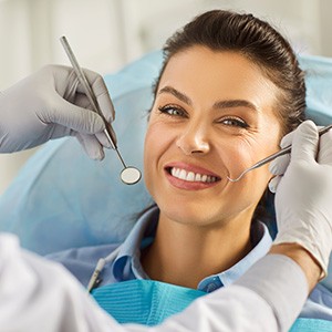 Patient with dental implants smiling during routine checkup
