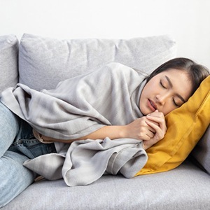 Lady sleeps on couch