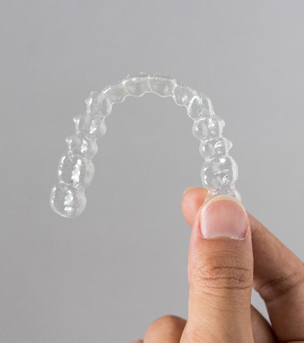 Patient holding clear aligner