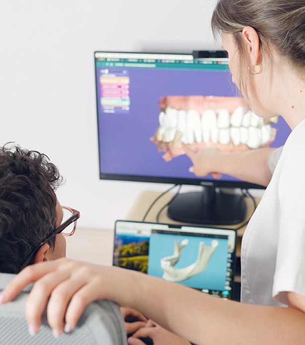 Dental team reviewing digital treatment plan for veneers with patient