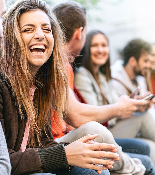 Patient in Loves Park laughing with friends after veneer treatment
