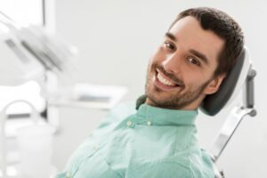 Man smiling while at the dentist